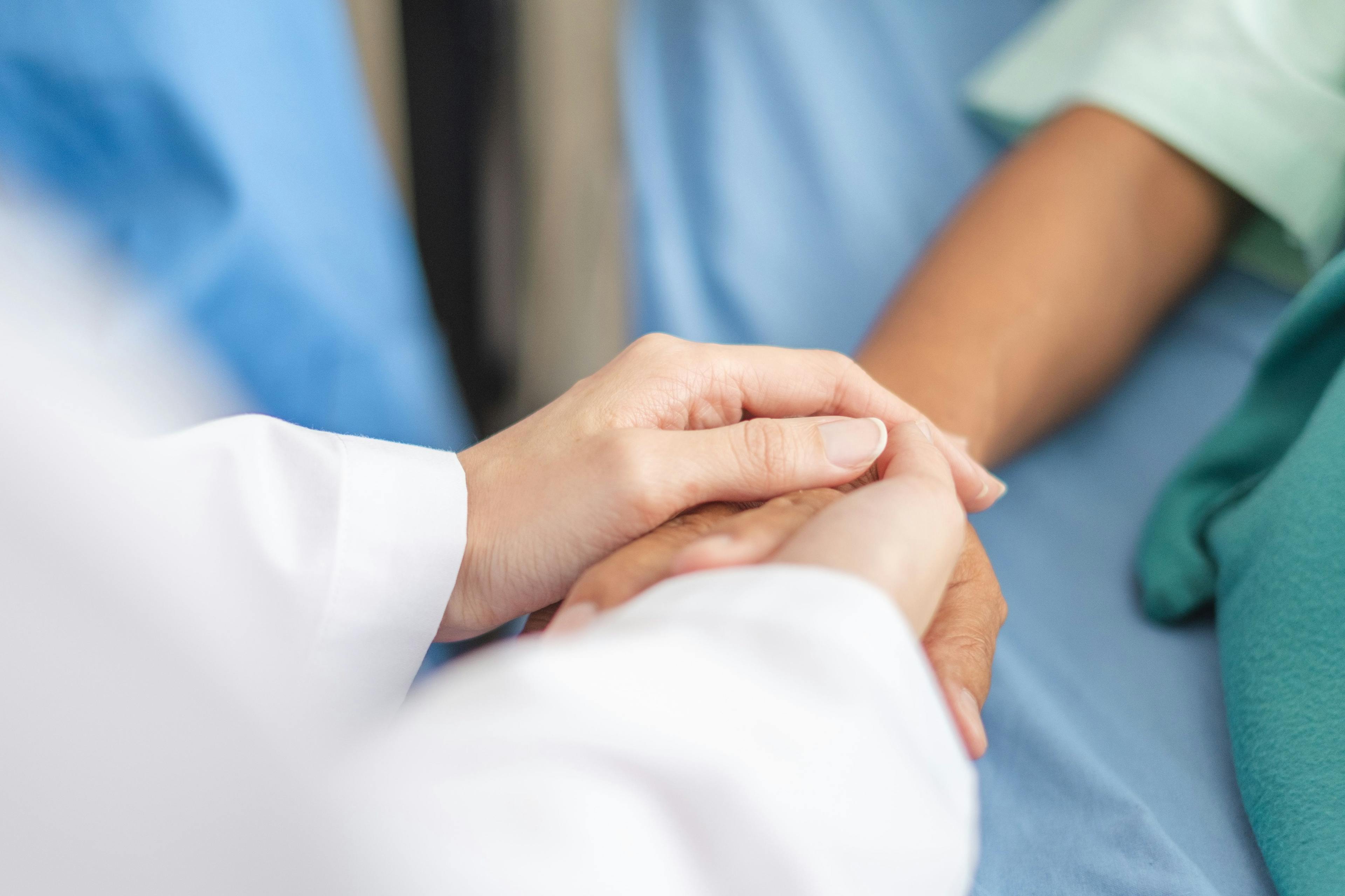 doctor patient holding hands 