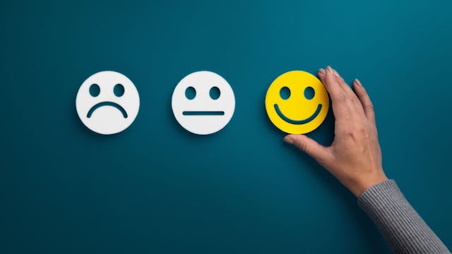 Image of three emotions, with the smiley face in yellow.