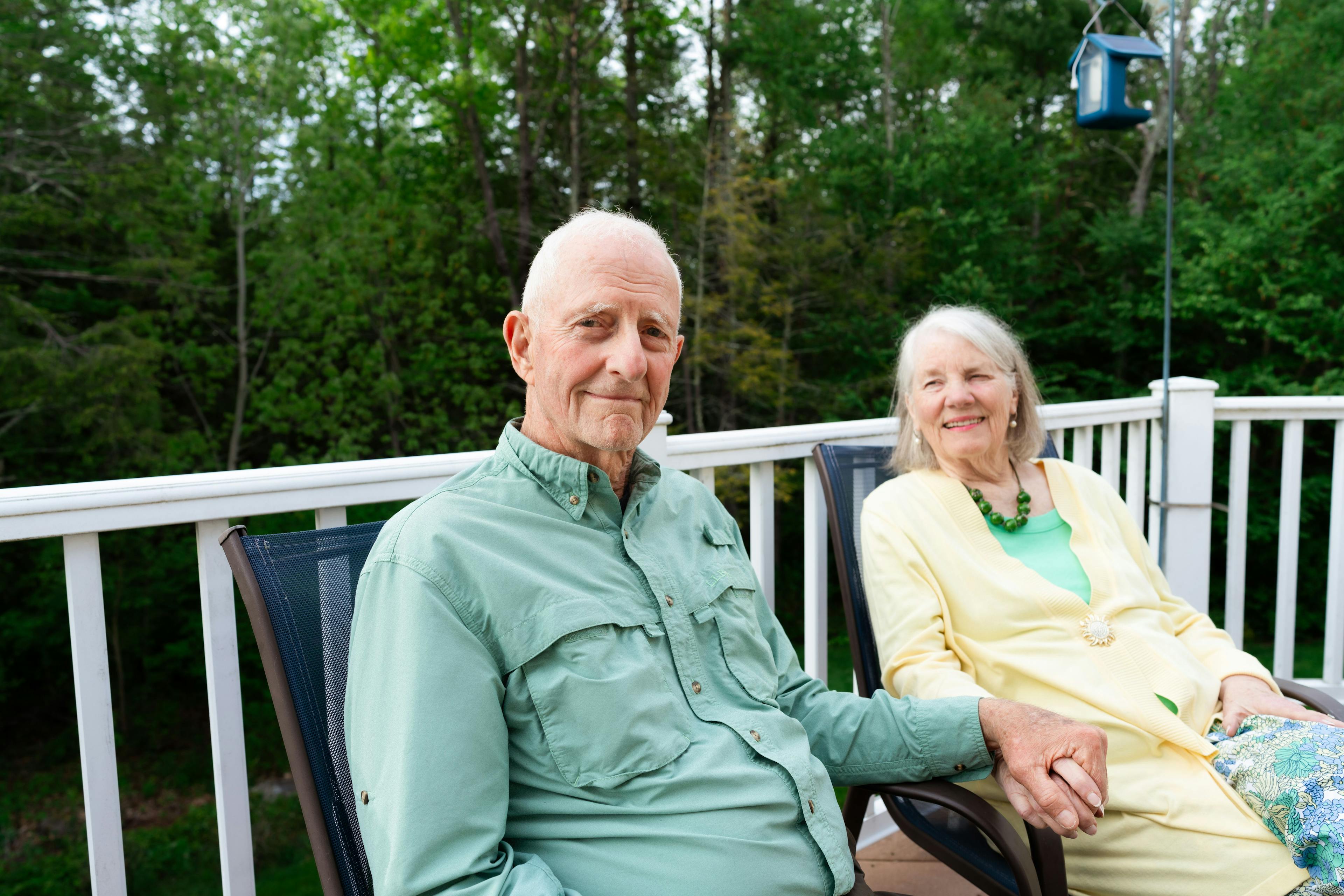Image of a man and woman sitting together on the porch. Photo credit: Dani Cournoyer