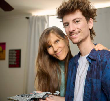 Image of a woman with long hair next to a man, both smiling. 