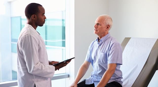 Image of a doctor speaking with a patient with prostate cancer.