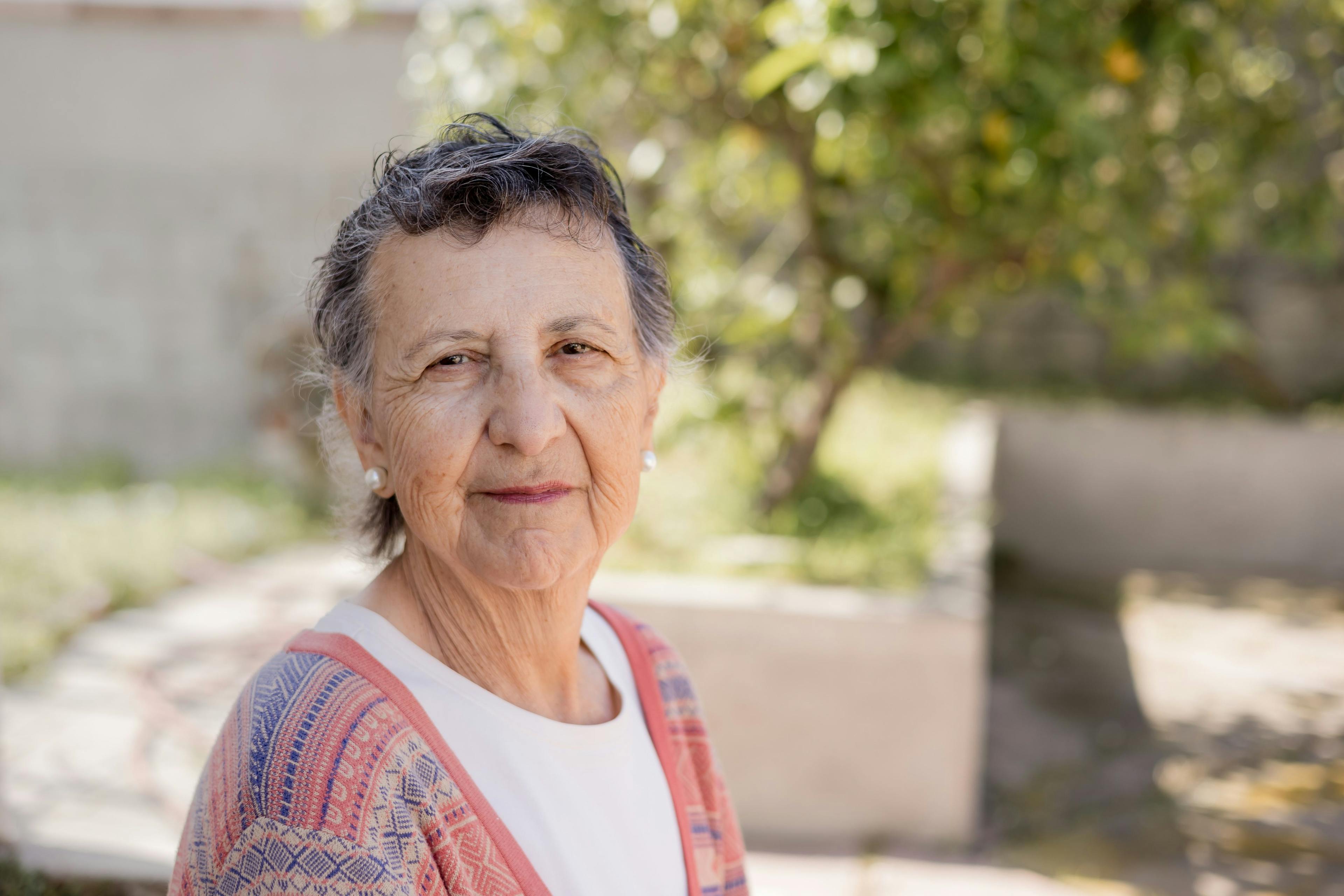 Image of a woman wearing a aztek-patterned cardigan. 