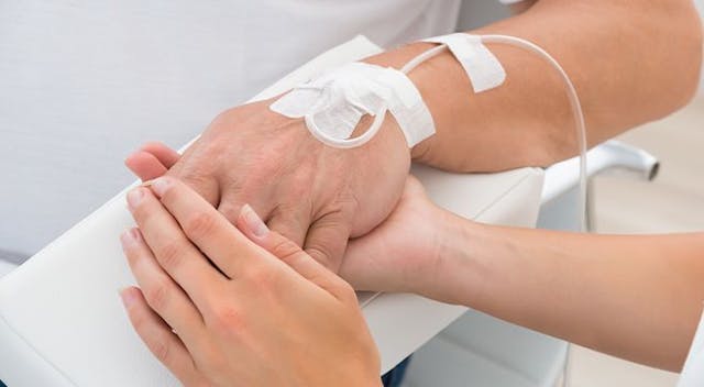 nurse holding patient's hand 