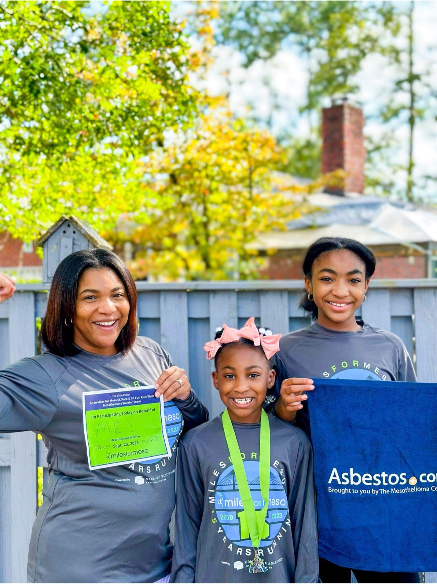 Image of a women with two children, smiling. 